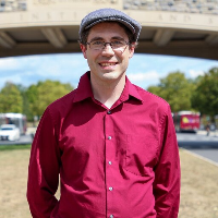 A headshot of Nathaniel Porter in a grey cap and red shirt on the
Virginia Tech campus